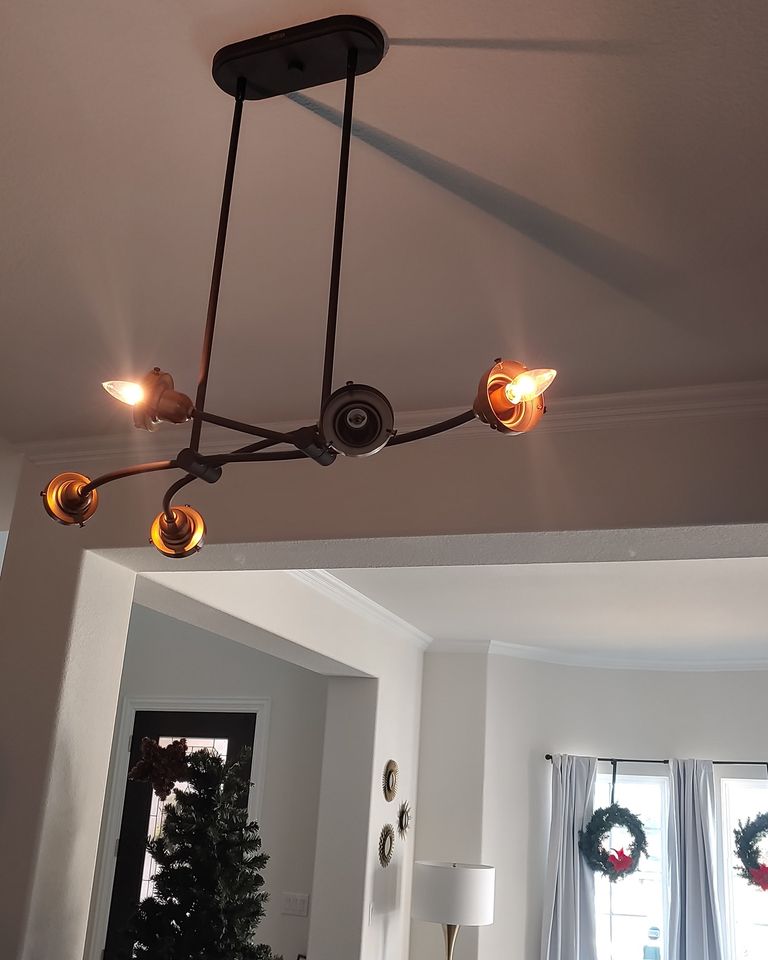 A chandelier hanging from a ceiling in a living room